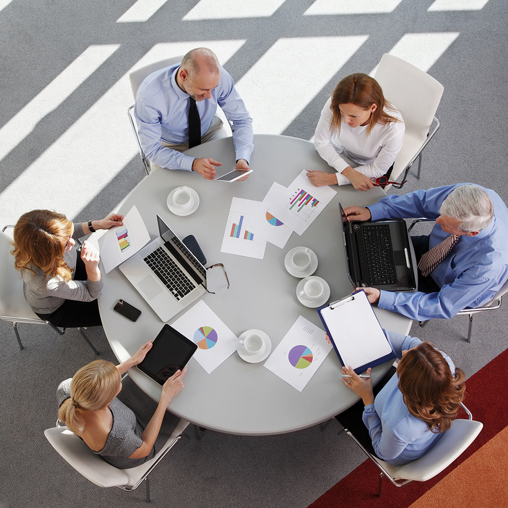 A sales team checking some graphs on a round table